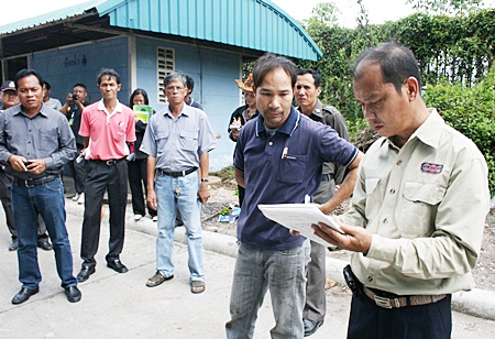 Bankai Sub-district Mayor Sanit Putsang instructs a Mit Steel manager to clean drains and construct a storage tank in order to reduce toxic effects on the neighboring villagers.